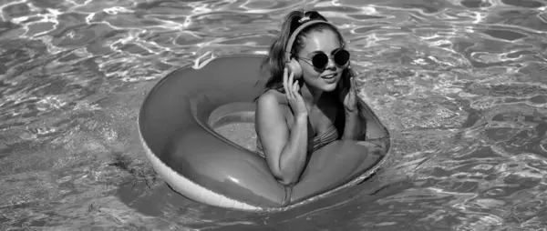 Summer mood concept. Pool resort. Girl on swim ring. Summertime days
