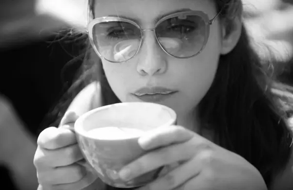 Closeup portrait of woman with cup coffee. Coffee. Beautiful Girl Drinking Tea. Cup of Hot Beverage. Close up woman lip with mouth drink latte