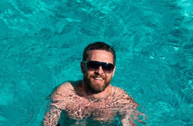 Güneş gözlüklü yakışıklı adam. Yaz tatili. Havuz partisi. Yaz tatili