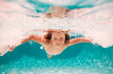 Child swim under water in sea. Kid swimming in pool underwater. Happy boy swims in sea underwater. Children in water. Kids beach fun