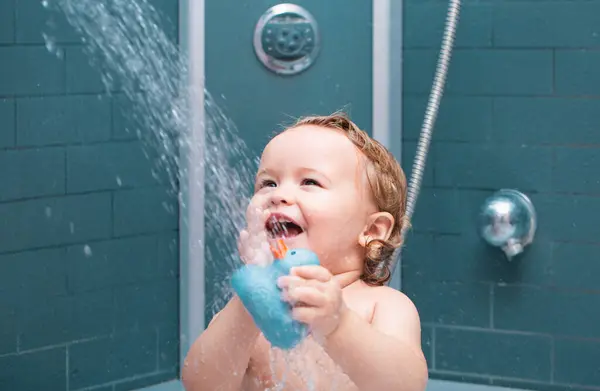 Happy funny baby bathed in the bath. Child in shower