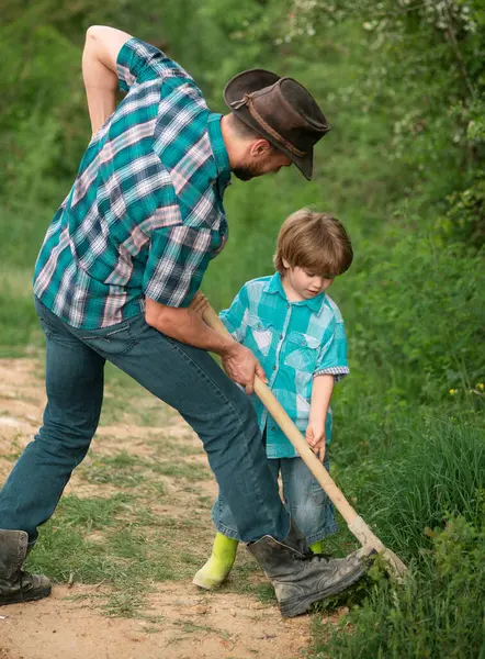 Father and son and wearing shirt planting tree