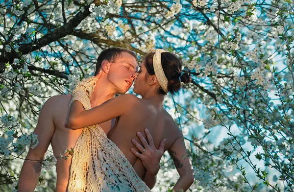 Sensual spring couple. Honeymoon. Cherry blossom tree. Springtime Nature. Love story