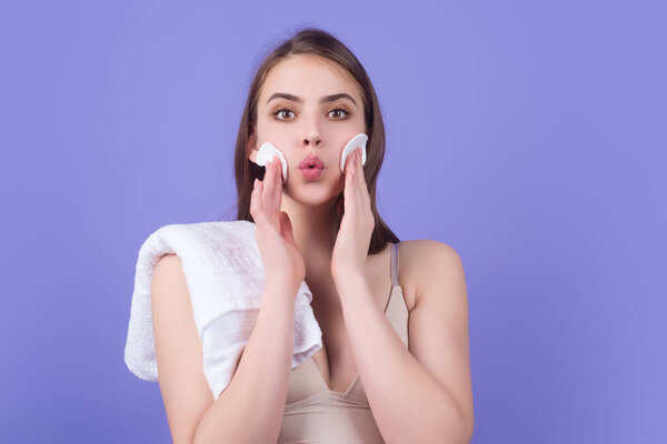 Woman removing makeup, holds cotton pads. Cleansing treatment care for skin with cotton pad. Young woman beauty model applying skin care product using a cotton pad
