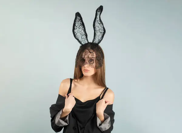 Sexy woman with bunny ears. Easter bunny isolated on studio background. Holidays, spring and party concept. Portrait of lovely, sensual girl in rabbit ears celebrating Easter