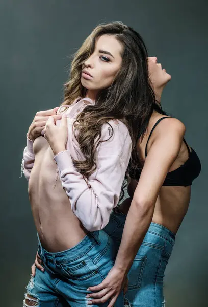 Role game with two sexy women. Beauty and fashion. Sensual women. trendy look. Sexy girls. Seducing you. Feeling free and happy. lesbian love relations. friendship. fit body. lgbt concept.