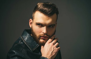 Yakışıklı, kendine güvenen adam. Stüdyoda poz veren ciddi biri. Şık saç kesimi, saç stili. Saç stili