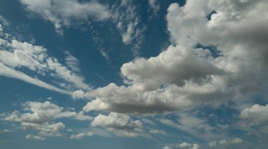 Yaz bulutları. Bulutlu gökyüzü. Çevresel ufuk çizgisinde bulutlu parlak mavi gökyüzü. Yumuşak arka planda beyaz bulutlar. Beyaz bulutlu gökyüzü
