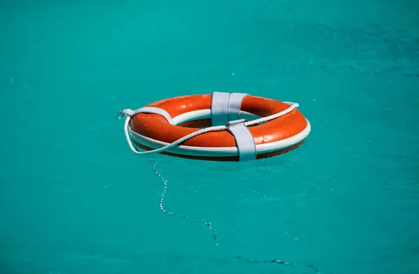 Life buoy for safety at pool in water. Safety equipment, rescue buoy floating to rescue people from drowning