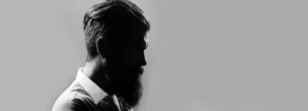 Closeup profile silhouette of bearded man with classic black long beard, bearded gay. Barber barbershop. Mustache men, serious face close up. Templates web banner design. Banner for website
