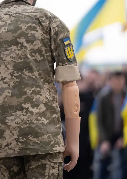 Ukrainian veteran soldier with prosthetic. War in Ukraine. Stop war. Troops of Ukraine. Russia Ukraine war, military protest. Ukrainian veteran rehabilitation, soldier with prosthetic arm
