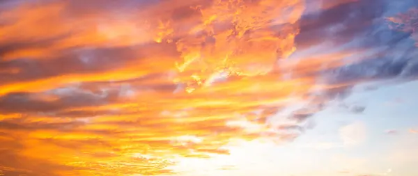 Dramatic Colorful Sunset Sky. Clouds with Sunrays. Cloudscape Sunset Background. Panorama Sky. Dramatic sky with clouds at sunset or sunrise. Sunset Sundown. Sky with colorful clouds