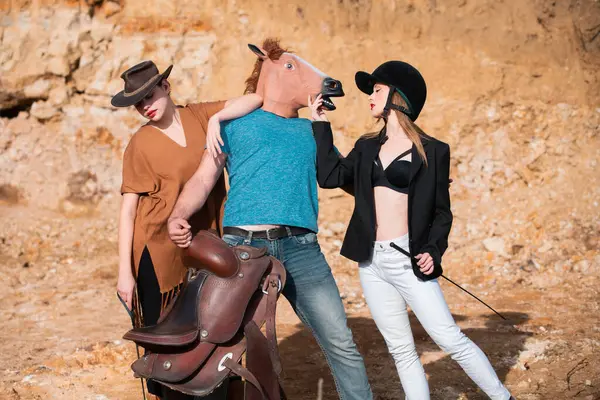 Crazy strange people with horse mask. Freaky young horsewoman women and crazy comic man with horse mask. Funny horse head. Comical Funny people. Absurd and funny friends. Fake and humor