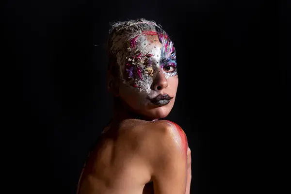Art Portrait of young woman with art make-up. The Body Art. Abstract face paint. Model with creative art makeup. Creative body paint and hairdo. Woman in paint. Attractive female Face draw