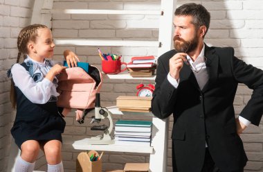 Dad primary pupil kid daughter preparing school homework. Studying homeschooling with father. Children education, home schooling concept
