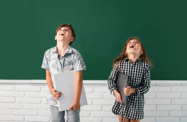 School Children Hold Book Surprising Expression Blackboard School Kids Friends — Stock Photo, Image