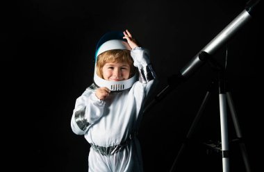 Uzayda sevimli bir astronot çocuk. Çocuk kendini astronot kaskı takmış bir astronot olarak hayal ediyor. Astronot kasklı komik çocuk portresi