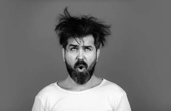 Funny and crazy. Bearded man with messy hair. Barbershop concept. Long beard and moustache