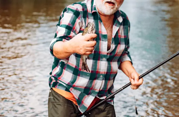 Fish on the hook. sport fishing. Fisherman and trout. Fish head and fishing hook. Bass fishing