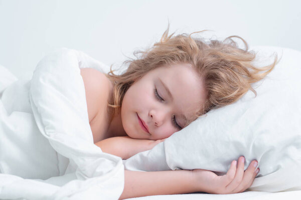 Bedding kid. Little boy sleeping in bed. Cute kid sleeping well alone in bed under blanket. Kid lying on comfort pillow, adorable small child rest asleep, enjoy good healthy sleep or nap