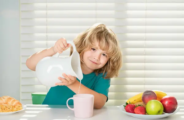 Kid boy pouring whole cows milk. Kid eating healthy food vegetables. Breakfast with milk, fruits and vegetables. Child eating during lunch or dinner