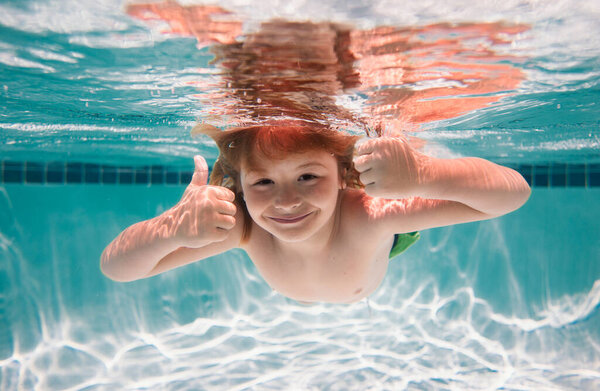 Child swim under water in sea. Kid swimming in pool underwater. Happy boy swims in sea underwater. Children in water. Summer vacation