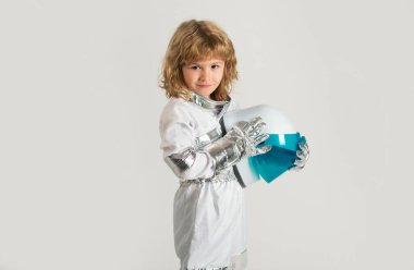 Small child wants to fly an in space holding astronaut helmet. Copy space