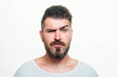 Serious man portrait. Beard and mustache. Looks seriously. Isolated. Hipster guy face expression. Closeup face