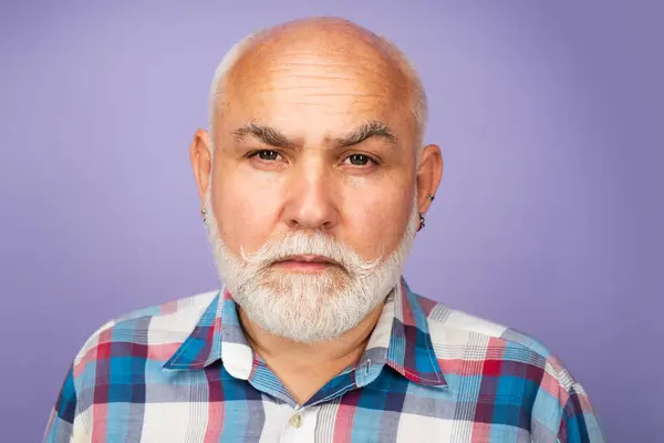 stock image Face of 60s elderly retired mature aged pensioner. Serious old mature senior man with grey beard on studio background