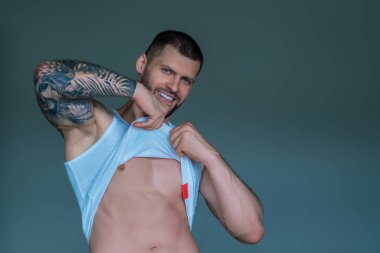 Handsome muscular man showing sexy body. Young sexy man portrait. Sexy guy with athletic flexing muscles. Sexy young handsome naked man. Seductive gay