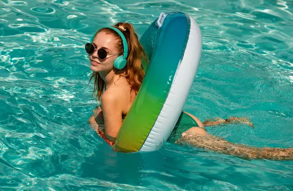 Summer mood. Pool resort. Girl on inflatable ring. Hot summer day. Vacation concept