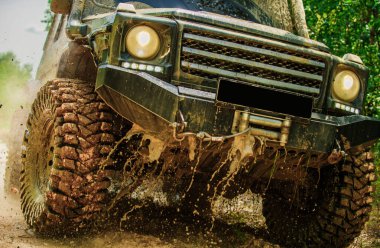 Alt manzaradan büyük off-road araba tekerine, şehir yolu ve dağ zemininde. Tekerlekleri ve kumdaki toza dönen off-road 'u hareket ettir.