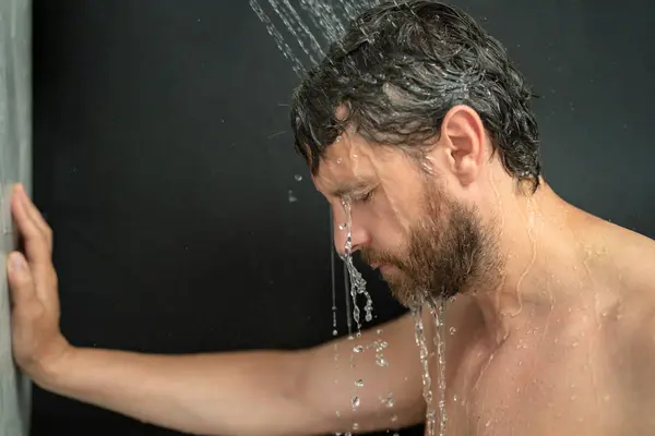 stock image Man washing hair, closeup portrait. Bathing shower washing hair head in bathroom. Male model washing hairs in shower. Man taking shower. Guy showering, hair care. Male shampoo and washing hair concept