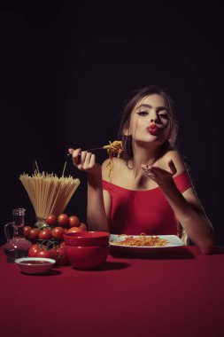 Sexy kitchen. Sexy Woman in the kitchen cooking Pasta. Italian Pasta concept. Homestyle pasta love. Noodles or spaghetti. Sensual woman eating spaghetti. Image of a Beautiful Woman Eating Pasta clipart