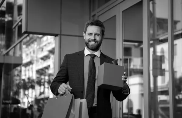 Man in suit with shopping bags. Best price. Total sale. Businessman enjoying shopping. Excited smiling guy doing shopping. Nice purchase. Gifts for holidays