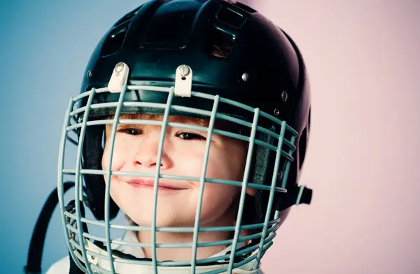 Safety and protection. Protective grid on face. Sport equipment. Hockey or rugby helmet. Sport childhood. Future sport star. Sport upbringing and career. Boy cute child wear hockey helmet close up.