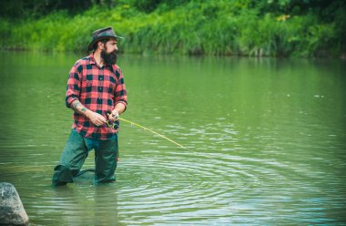 Man with fishing rod, fisherman men in river water outdoor. Summer fishing hobby