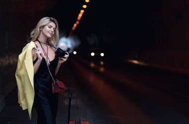 Traveler female student or young tourist. Tourist woman with travel bag walking on city street outdoor. Traveling abroad on weekends