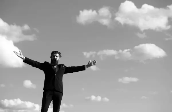 stock image Man in suit raising hand on sky background. Freedom adventure and business victory concept. Success business and freedom
