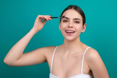 Mascara eyebrows. Natural beauty brows. Eyebrows coloring and lamination. Woman combing eyebrows. Makeup and cosmetology concept. Eyebrow shape modeling