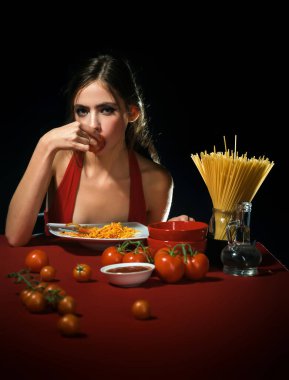 Close up sexy lips with noodles pasta. Female mouth eat pasta. Young beautiful woman eating spaghetti. Cuisine girl. Sexy woman eating pasta on kitchen. Woman cooked pasta clipart