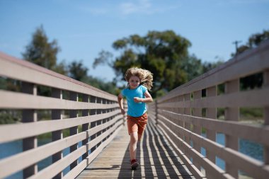 Morning running with children. Child runner running in the nature. Morning jogging. Active healthy kids lifestyle