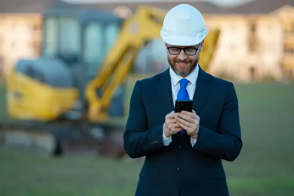 Engineer, construction manager or supervisor at a construction. Supervisor in suit and helmet. Investor, construction manager at a construction. Developer, outdoor portrait . Middle aged architect