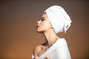 Güzel yüzlü, pürüzsüz ciltli, çıplak omuzlu, şehvetli bir kadın. Gökyüzü arka planında doğal makyajı ve güzel gözleri olan seksi bir model. Çıplak omuzlu güzel seksi manken kız.