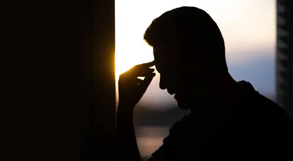 stock image Tired man suffering from headache, touching head, relieving pain, migraine. Business problems. Bankruptcy, financial problem and crisis concept. Millennial hispanic man having headache. Migraine