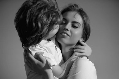 Mother kiss. Closeup portrait of mother and child kissing. Mother hugging and embracing son. Mothers day, love family. Mother and child with tenderness. Mothers kiss child, cuddle warm relationships