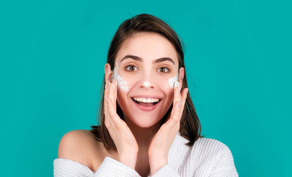 Moisture for skin. Beautiful woman apply a cleansing mask on face. Female skin care, close up face beauty portrait