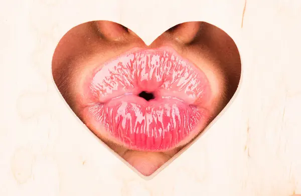 Lips in heart shape. Valentines day. Sensual womens kissing. Red lip with glossy lipgloss. Tongue and sexy kiss. Close up, macro with beautiful mouths