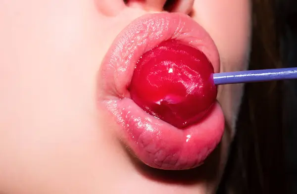 Sexual lips with candy, sexy sweet dreams. Female mouth licks chupa chups, sucks lollipop