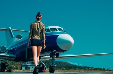 Çekici genç bayan hostes - geriye bakış. Yaşam tarzı ve seyahat. Havacılık ve ulaşım. Uçuş görevlisi üniforması. Uçuş görevlisi.